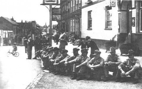 Australian soldiers sitting, uncharacteristically, outside a pub