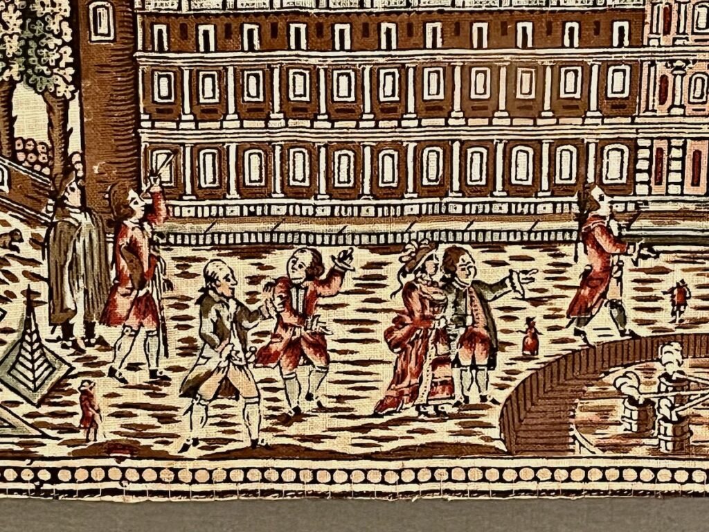 Detail of a handkerchief depicting several 18th-century figures conversing and gesturing, set against a detailed, multi-story building.