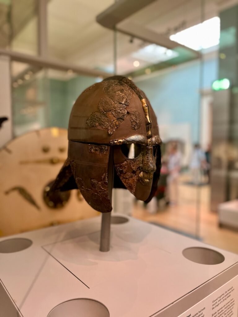 Ancient Anglo-Saxon helmet displayed in a museum exhibit.